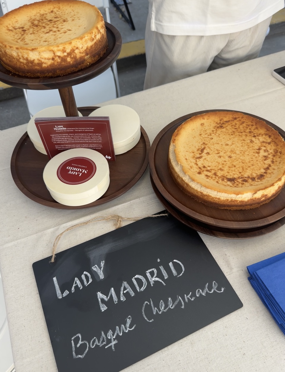 Lady Madrid cheesecakes displayed at a market table.